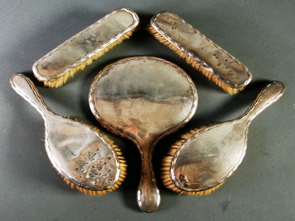 Appraisal: FIVE PIECE GEORGE V SILVER BACKED DRESSING TABLE HAND MIRROR