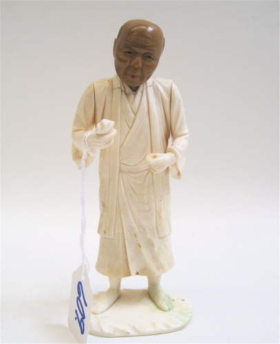 Appraisal: JAPANESE IVORY CARVING of a barefoot man standing holding food