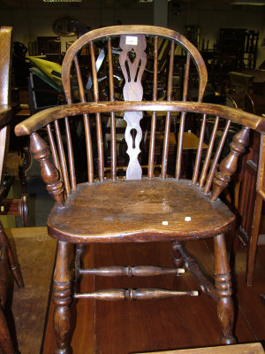 Appraisal: An ash and elm Windsor armchair pierced and spindle turned