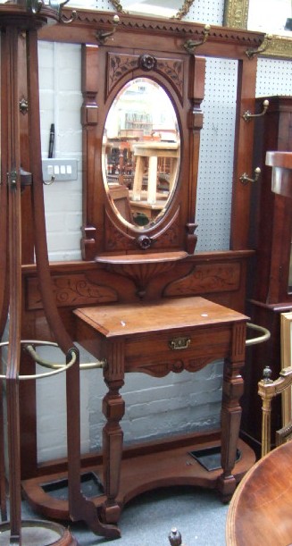 Appraisal: A mid Victorian carved walnut and brass mounted hall stand