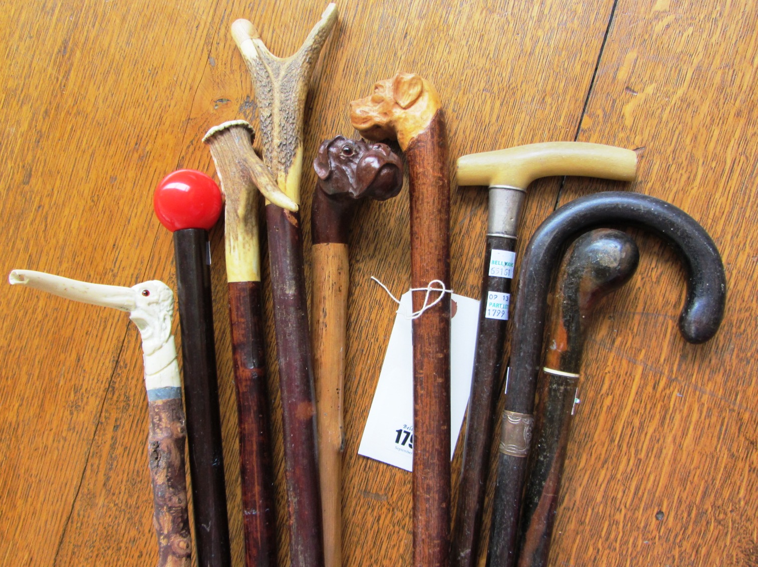 Appraisal: A quantity of walking sticks two with carved dog pommel