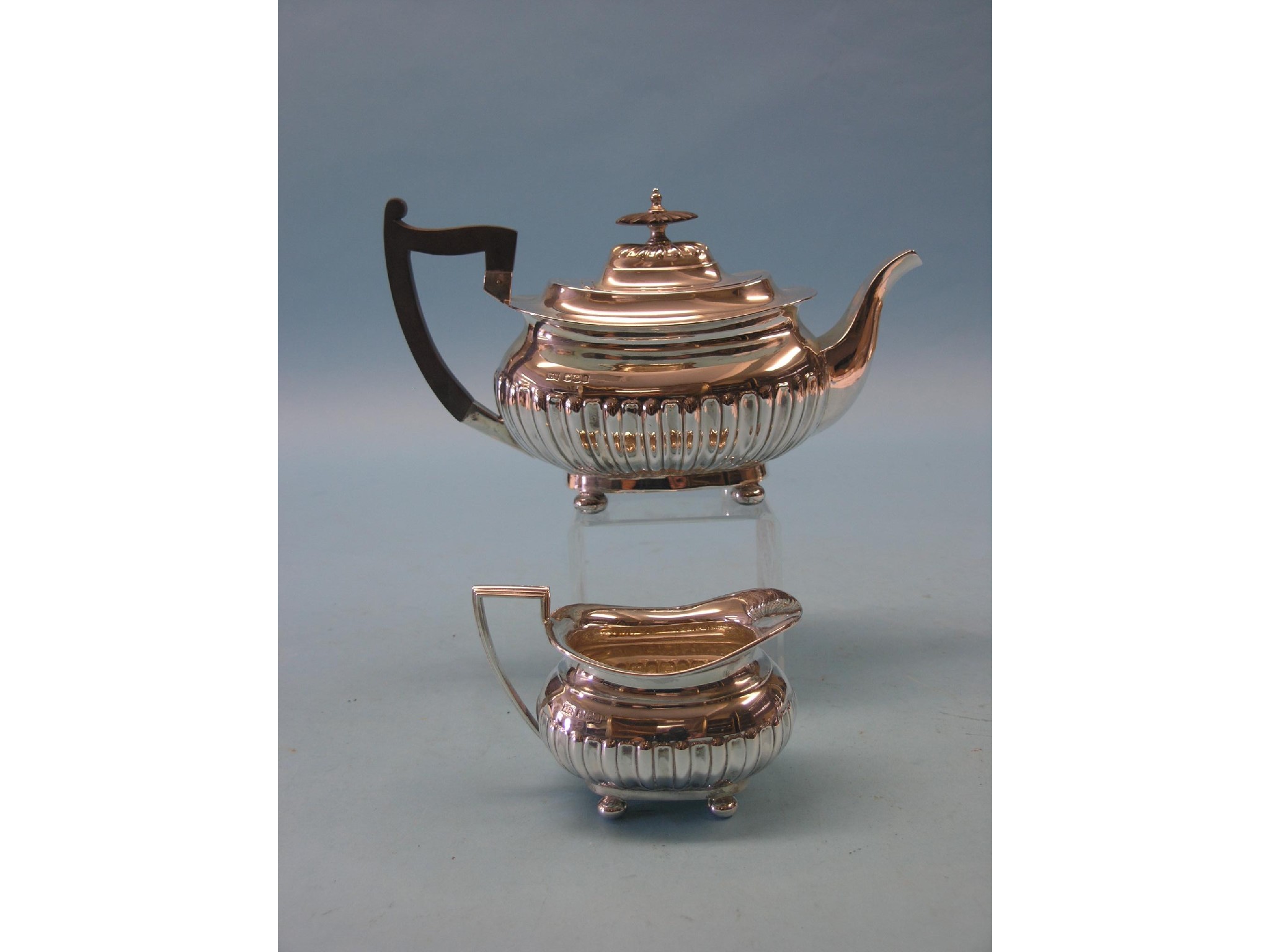 Appraisal: A silver teapot and matching milk jug Sheffield approx oz