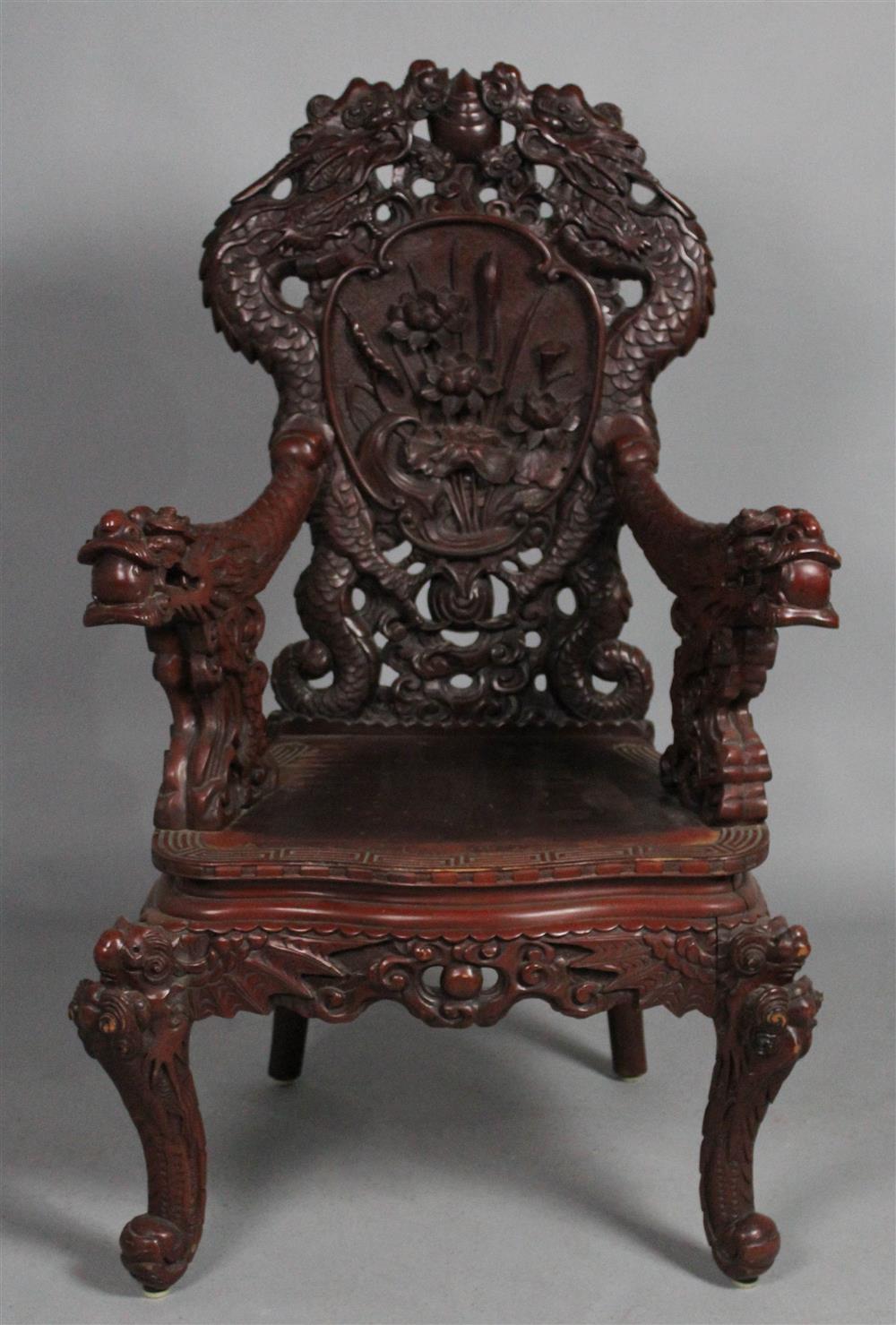 Appraisal: JAPANESE SCARLET LACQUERED ARM CHAIR elaborately carved with dragons stands