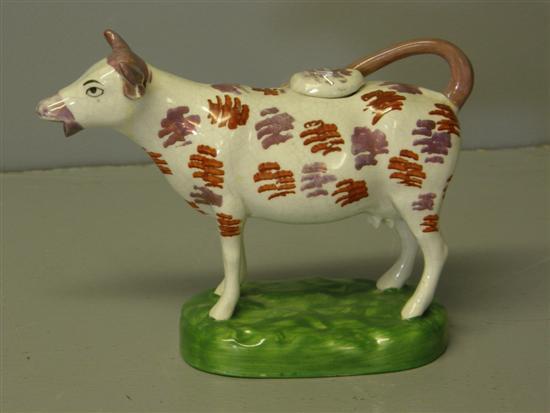 Appraisal: Sunderland lustre cow creamer with a looped tail on green