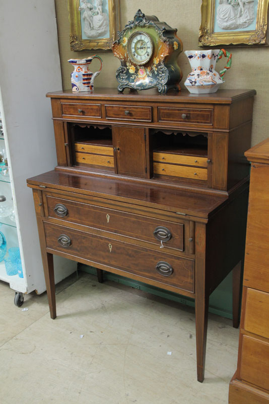 Appraisal: SECRETARY Walnut with three top drawers above two tambour doors