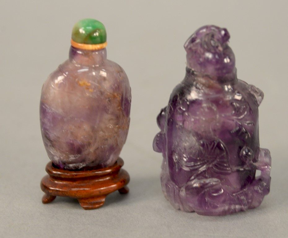 Appraisal: Two amethyst quartz snuff bottles one carved relief with Guanyin