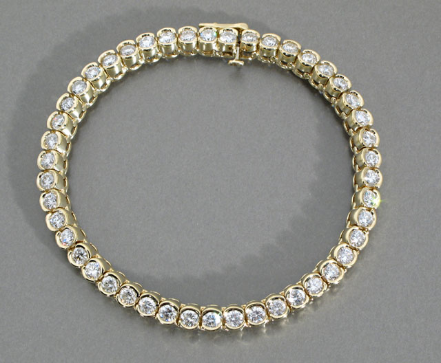 Appraisal: DIAMOND AND FOURTEEN KARAT GOLD LINE BRACELET with round links