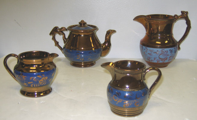 Appraisal: FOUR PIECES ENGLISH COPPER LUSTRE WARE A teapot with bird