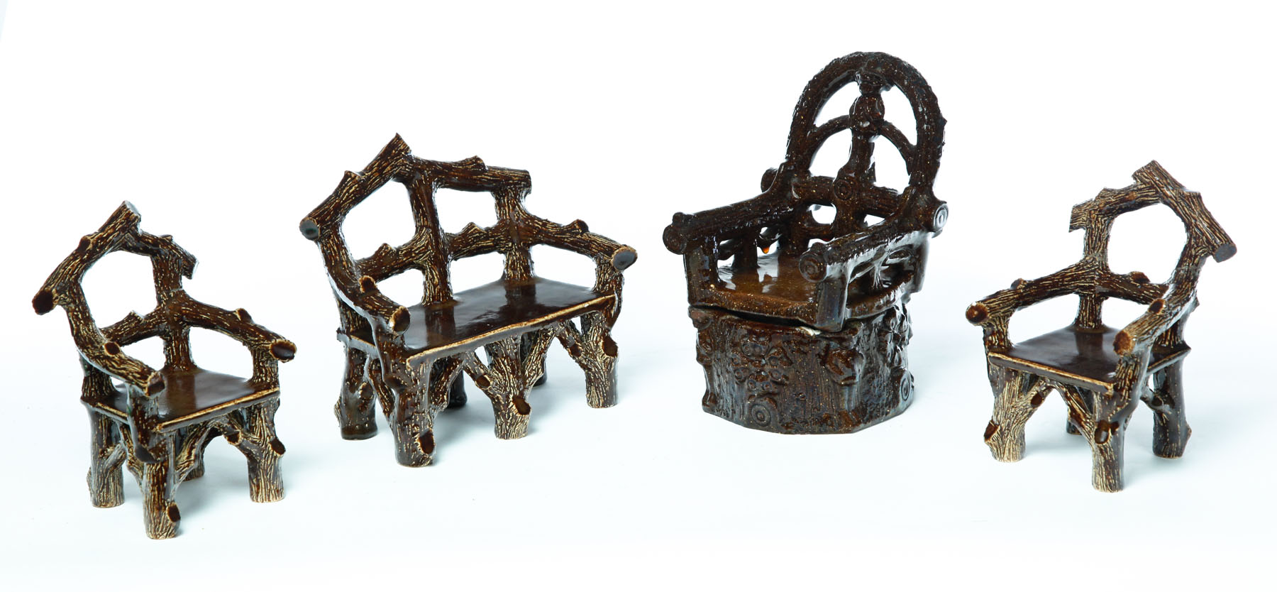 Appraisal: FOUR PIECES OF MINIATURE ADIRONDACK-STYLE POTTERY FURNITURE Midwest th century