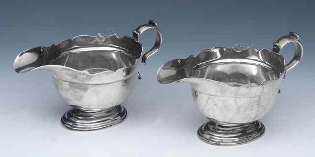 Appraisal: A PAIR OF GEORGE II SILVER SAUCE BOATS with wavy