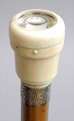 Appraisal: ENGLISH IVORY AND SILVER-MOUNTED FRUITWOOD WALKING STICK The ivory cup