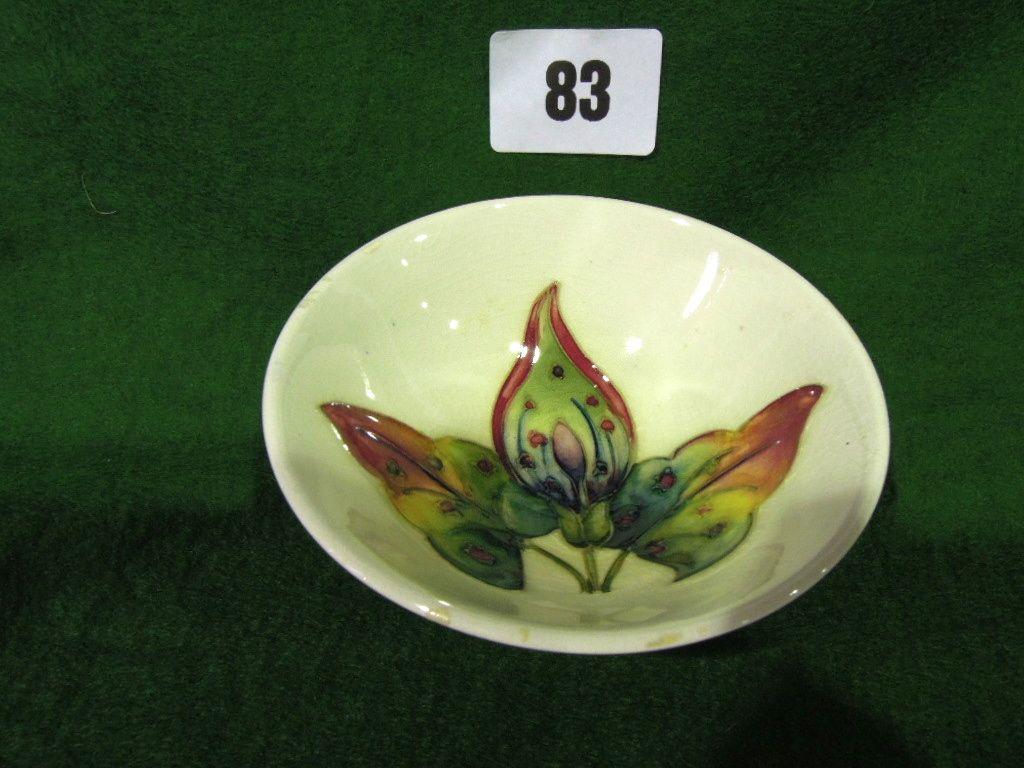 Appraisal: A Moorcroft pin dish with floral decoration on cream ground