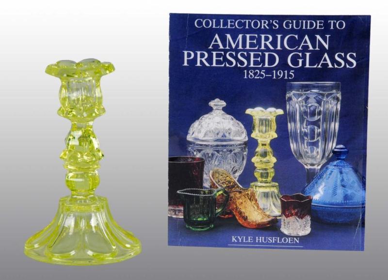 Appraisal: American Pressed Vaseline Glass Candlestick Description Circa Petal and loop