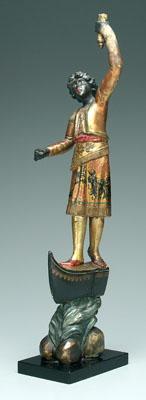 Appraisal: Carved and painted blackamoor figure astride the bow of a