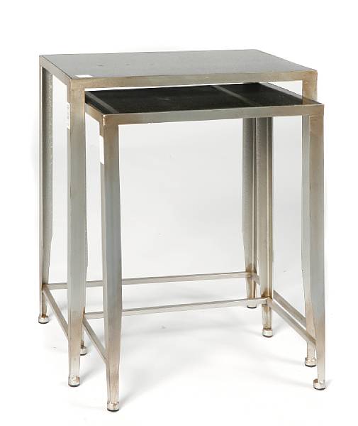 Appraisal: A pair of silvered metal nesting tables height of largest