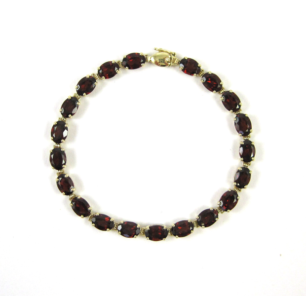 Appraisal: GARNET AND TEN KARAT GOLD TENNIS BRACELET measuring inches in