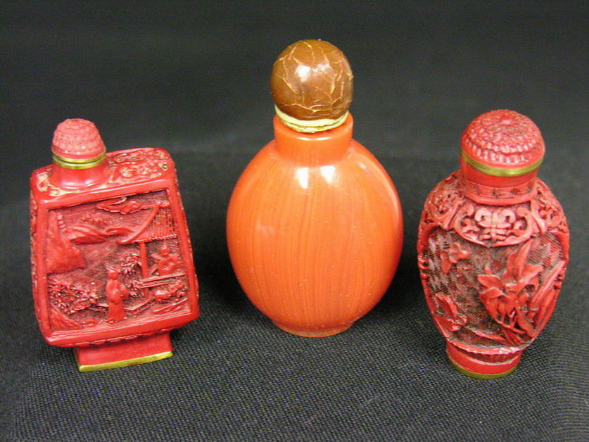 Appraisal: SNUFF BOTTLES Orange glass Cinnabar rectangular base Cinnabar round base