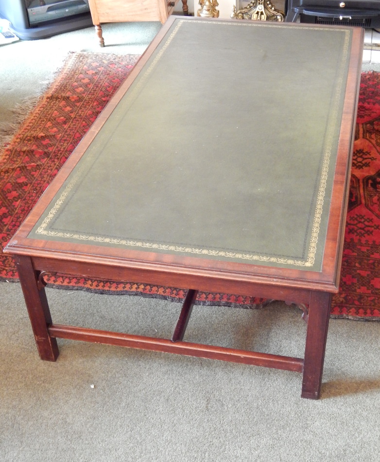 Appraisal: A mahogany coffee table the rectangular top with a green