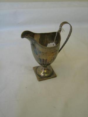 Appraisal: A GEORGIAN CREAM JUG of helmet form with reeded rim