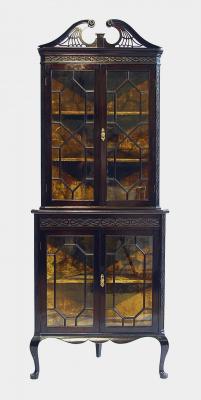 Appraisal: A VICTORIAN MAHOGANY STANDING GLAZED CORNER CUPBOARD with canted angles