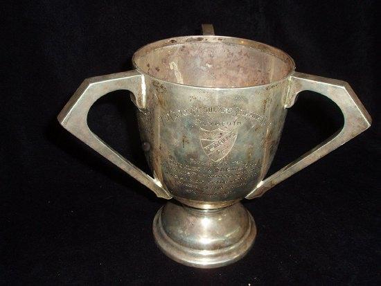 Appraisal: A three-handled trophy cup 'The 'O' clock Regulars Swimming Club