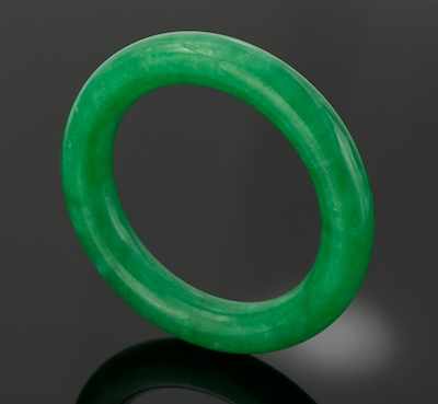 Appraisal: A Carved Jadeite Bangle Bracelet Cared with circular cross section