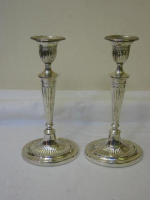 Appraisal: A PAIR OF EDWARDIAN CANDLESTICKS of fluted form with oval