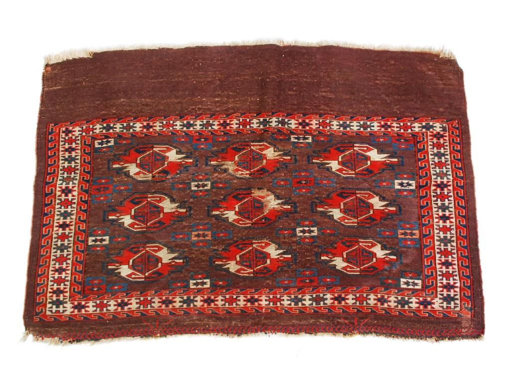 Appraisal: BOKHARA SADDLEBAG RUG the mulberry coloured ground with three rows