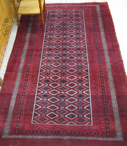 Appraisal: BELOUCHI TURKOMAN AREA RUG with centralized field of repeating diamond-shaped