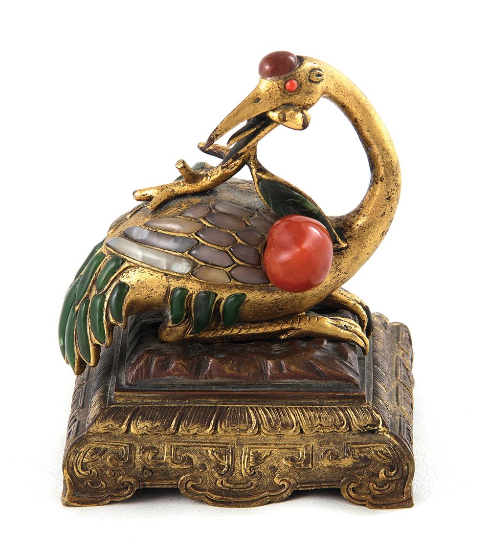 Appraisal: Chinese gemstone-inset bronze crane Qing dynasty resting bird holding peach