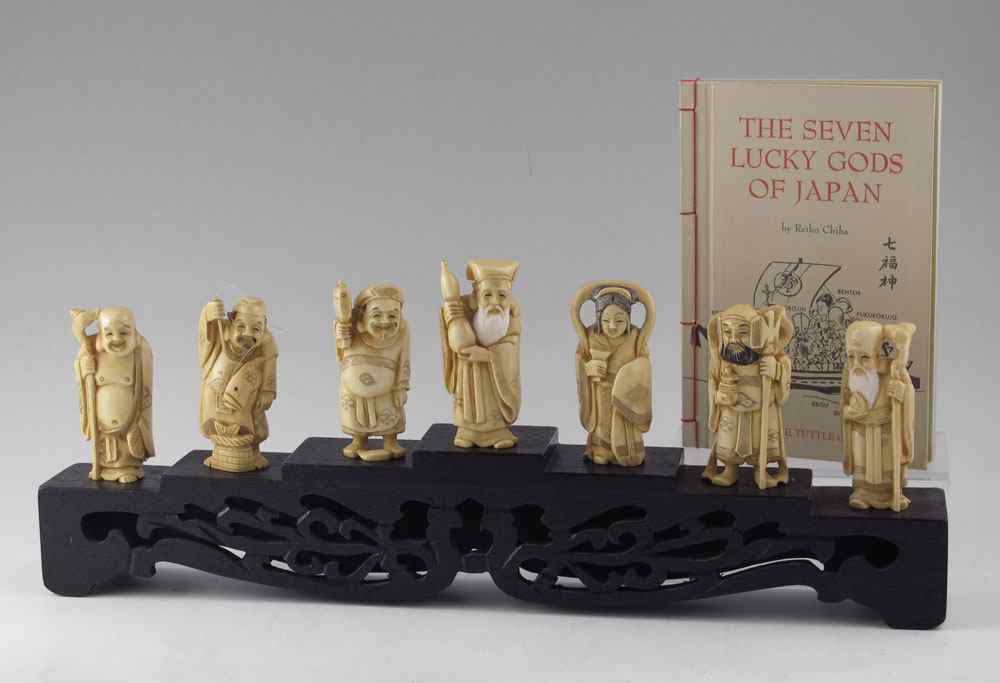 Appraisal: PIECE CARVED IVORY LUCKY GODS WITH STAND Set of Japanese