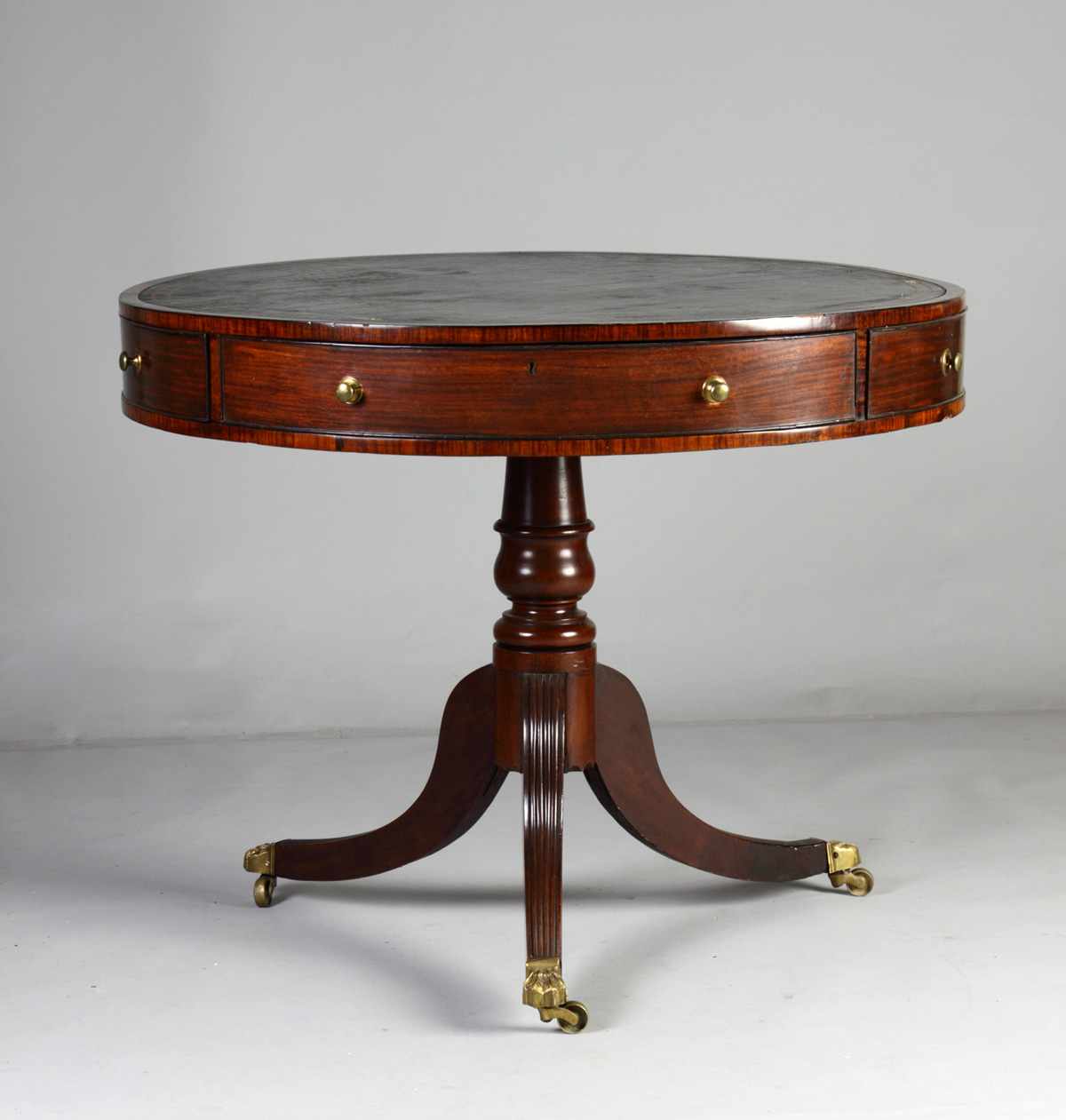 Appraisal: George III Mahogany Drum Table w Drawers Fluted legs brass