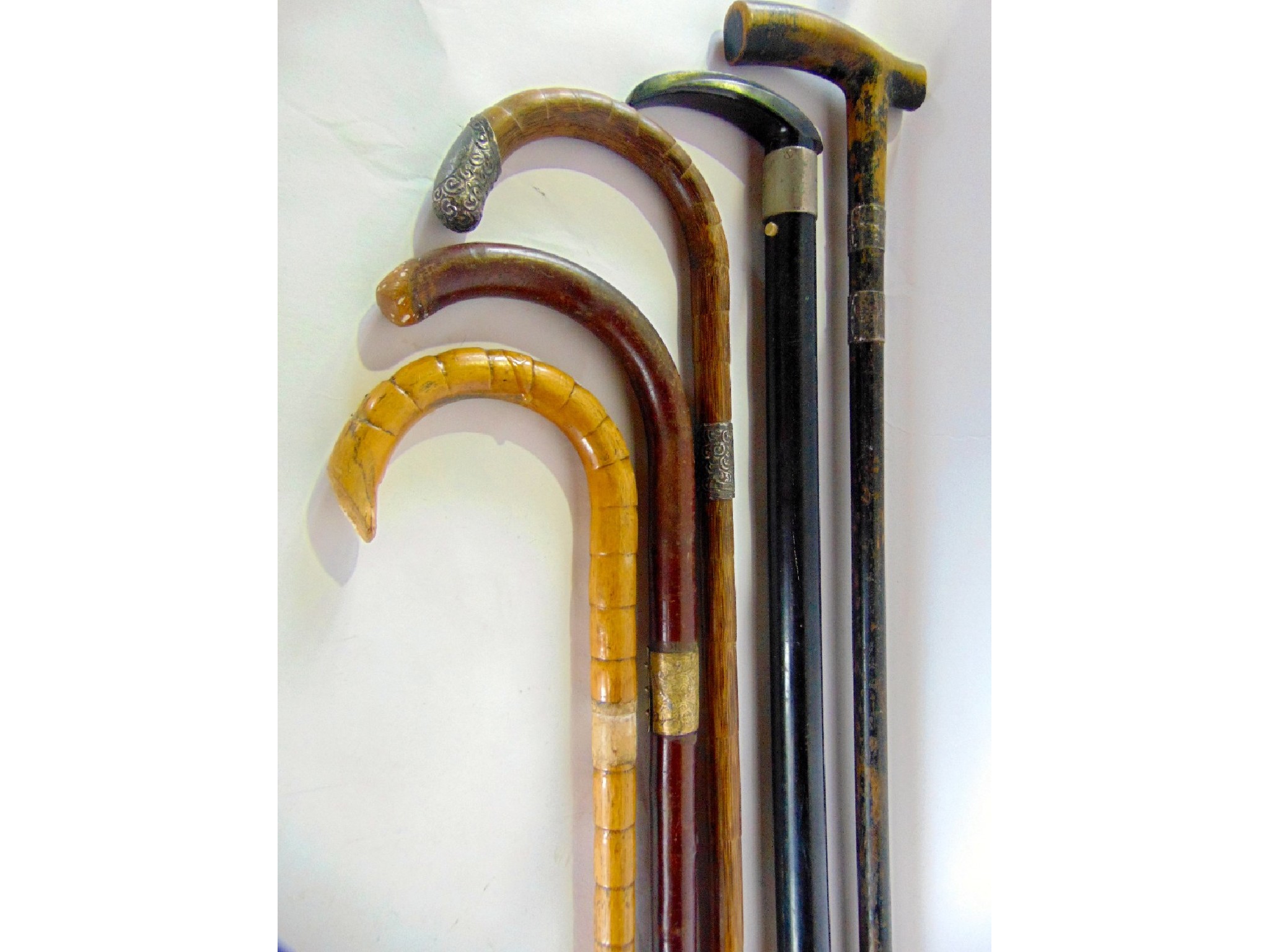 Appraisal: A bundle of old timber walking canes to include bamboo