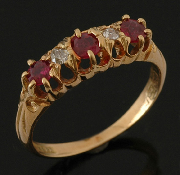 Appraisal: A ruby and diamond ring The half hoop design set