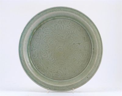 Appraisal: A Chinese pale celadon glazed dish incised with scrolling lotus