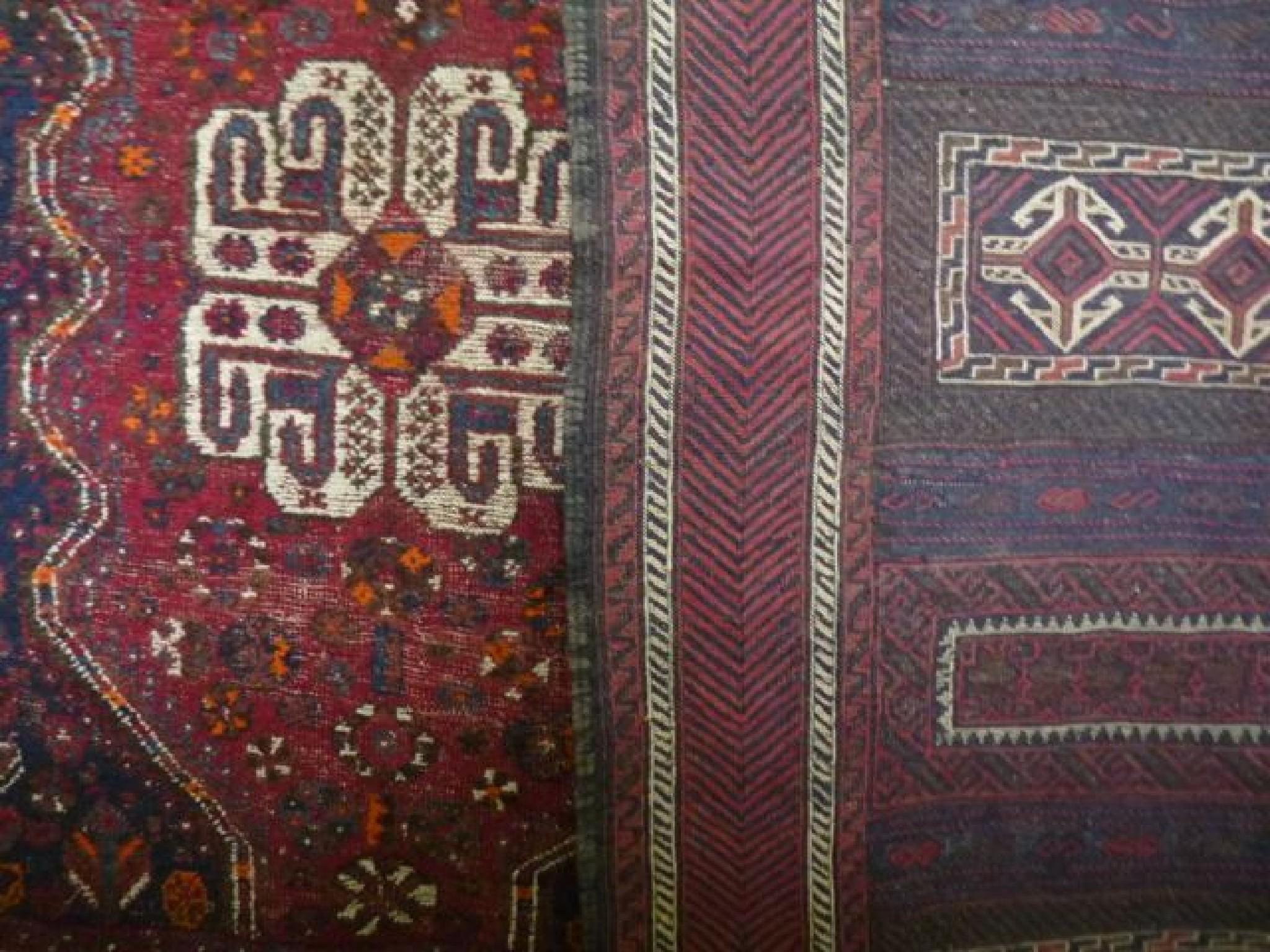 Appraisal: Two Persian rugs both red ground with geometric detail