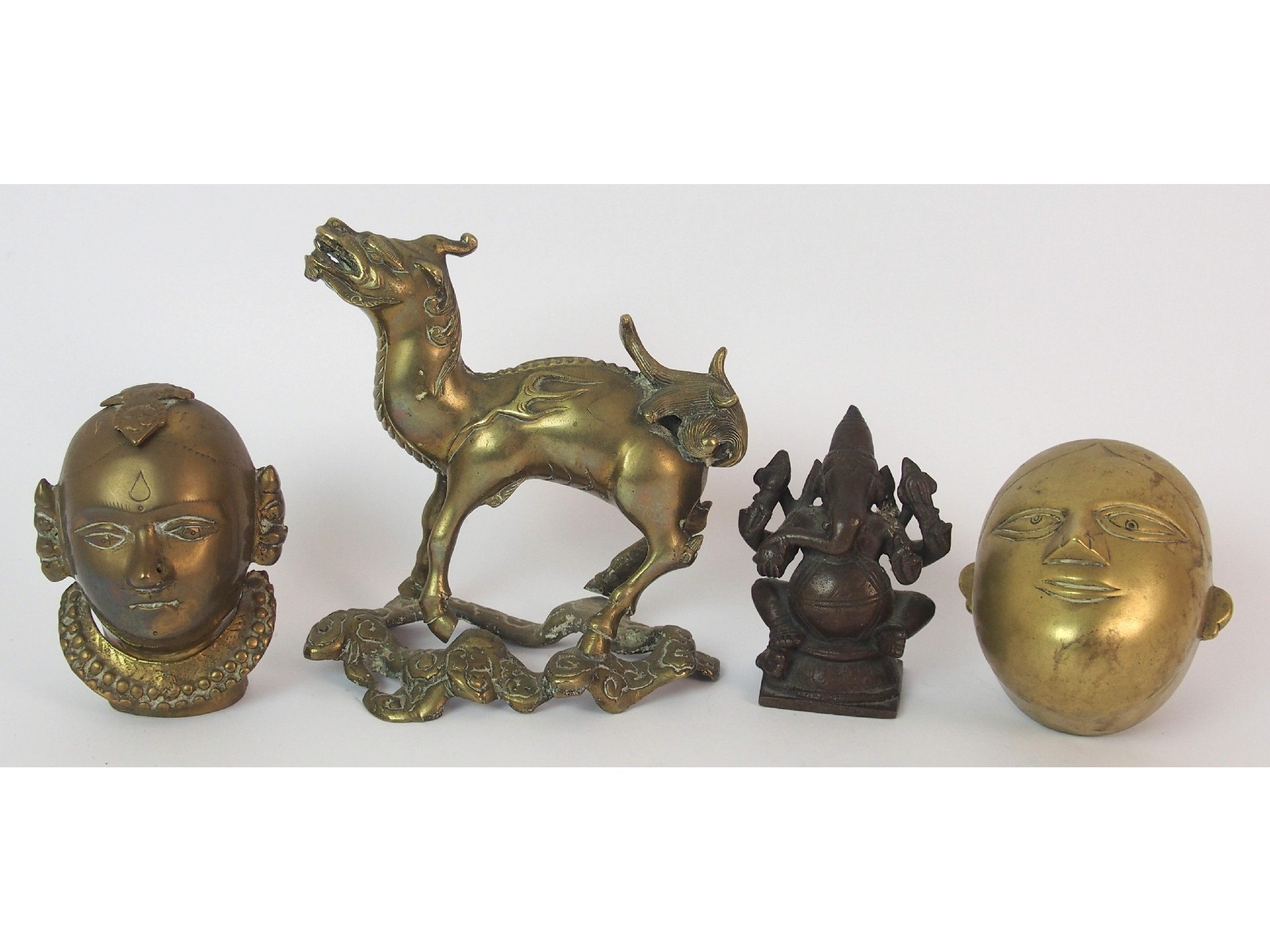 Appraisal: Two Indian brass heads cm high and cm wide bronze