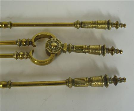 Appraisal: A set of th century brass fire irons comprising a