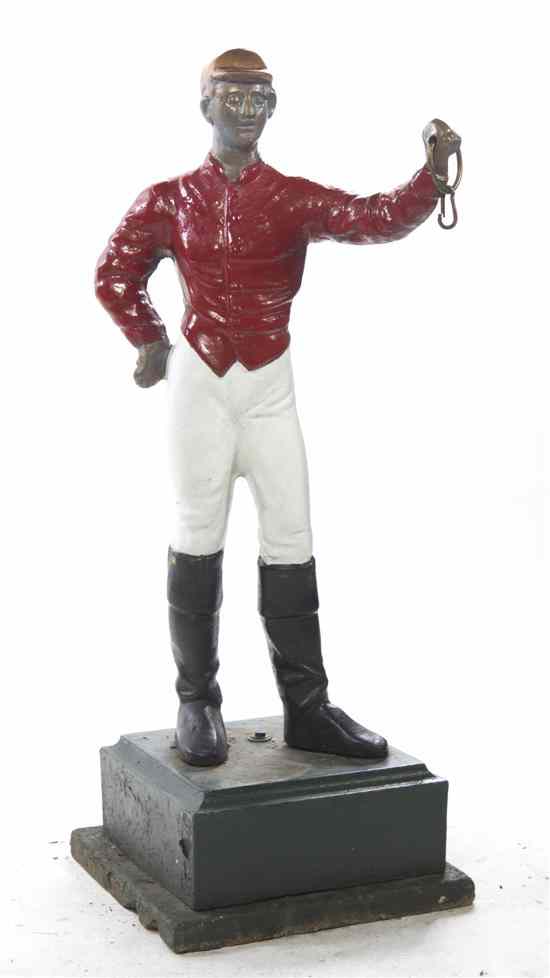 Appraisal: A Lawn Jockey of typical form holding a ring raised