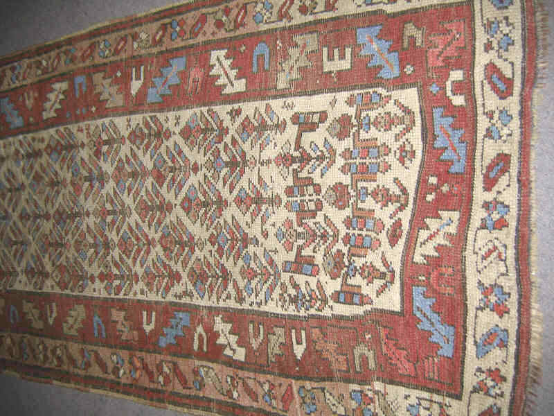 Appraisal: KURDISH TRIBAL LONG RUG The ivory field of all over