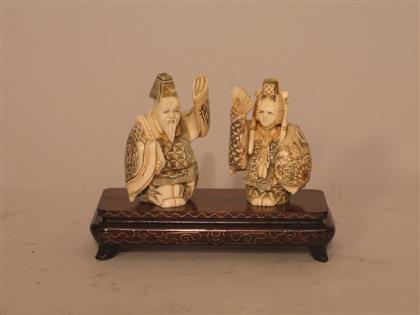 Appraisal: Two Carved Ivory Figures Holding Fans Japanese with stand male