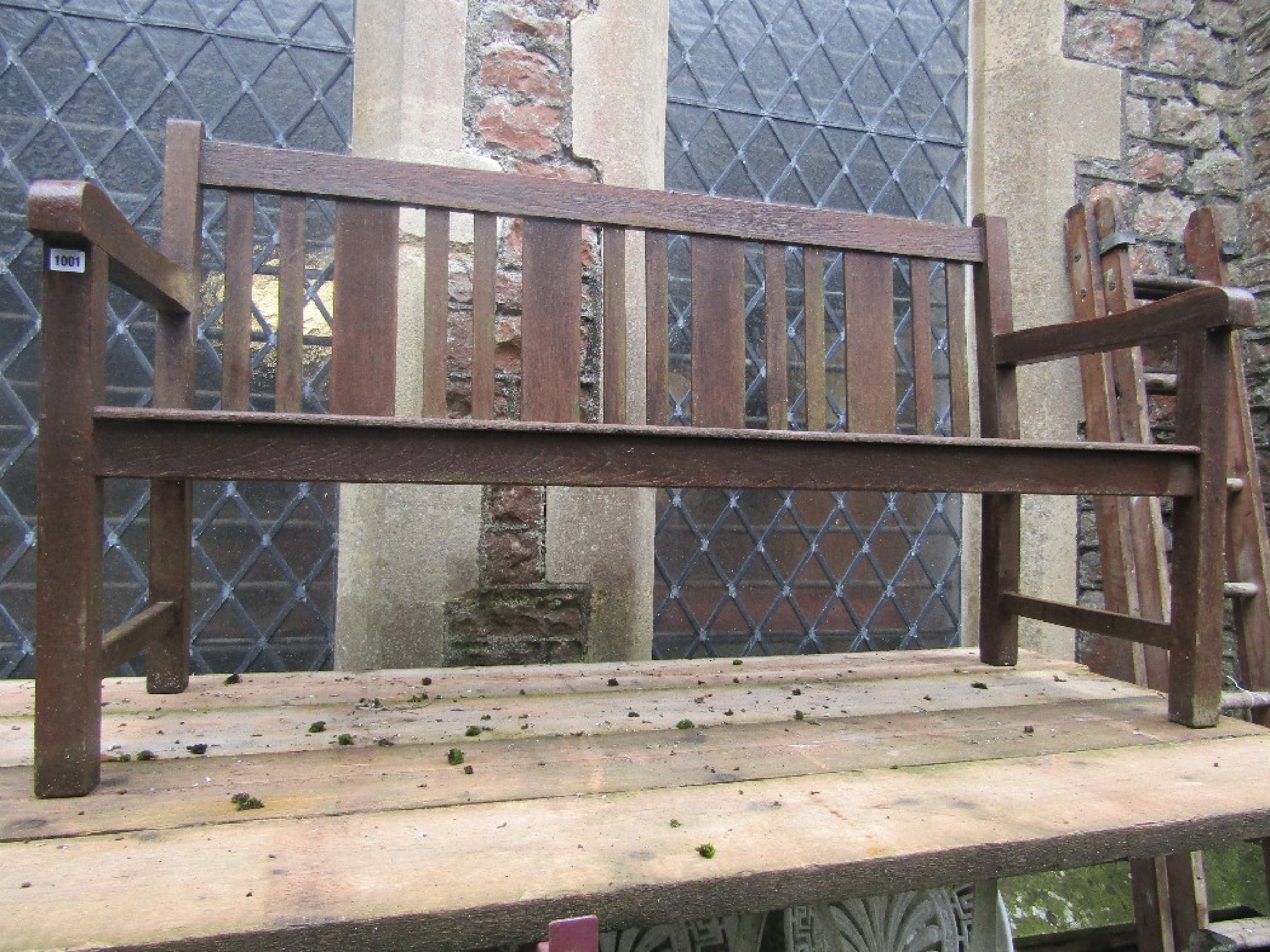 Appraisal: A stained hardwood three seat garden bench with slatted seat