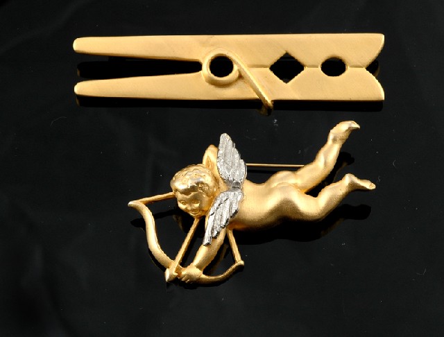 Appraisal: Two costume brooches by Schaparelli The goldtone brooches modelled as