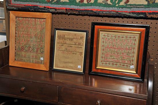 Appraisal: THREE FRAMED SAMPLERS Red and green wool on linen wrought