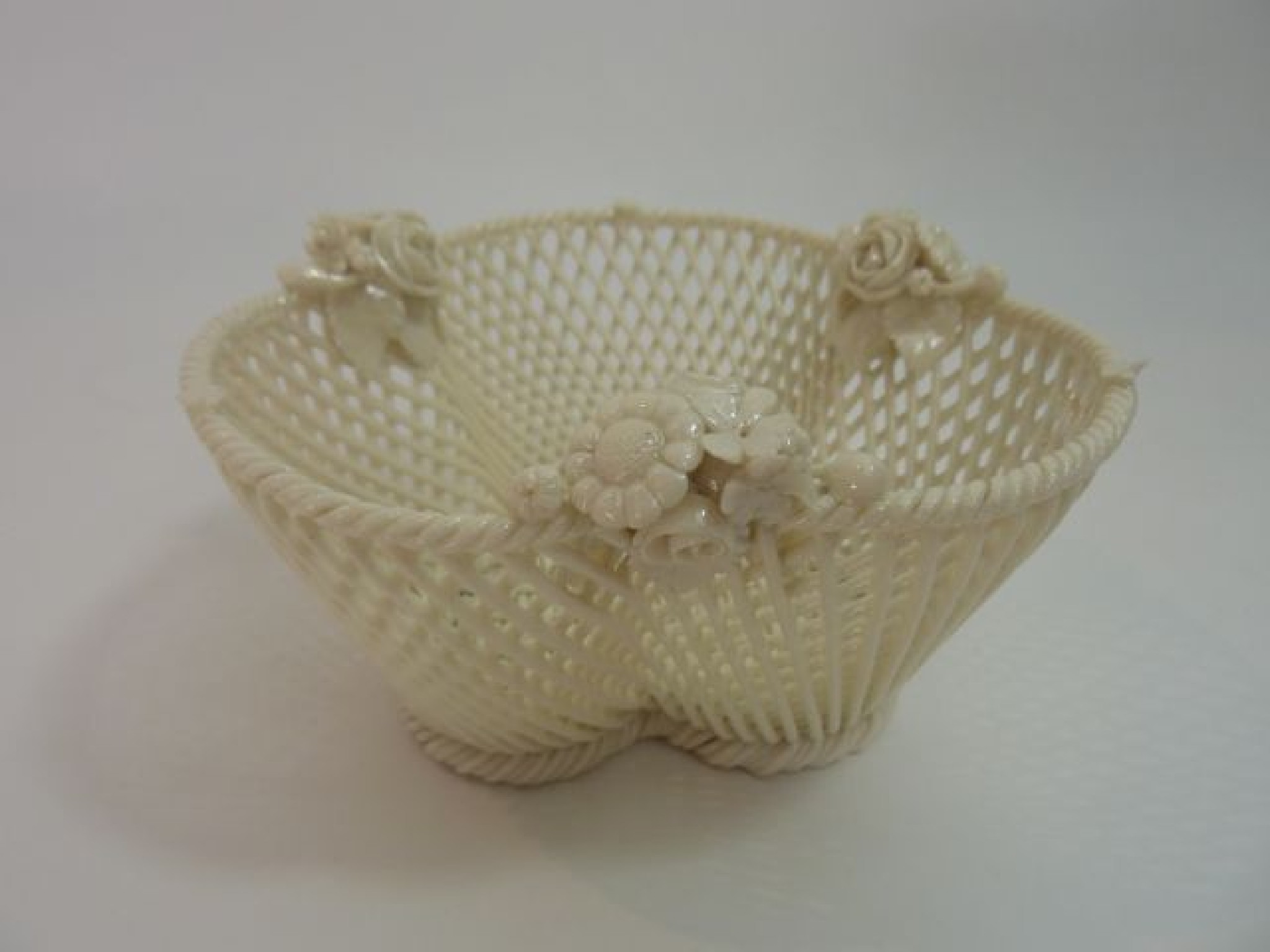 Appraisal: A th century Belleek basket of woven trefoil shaped form