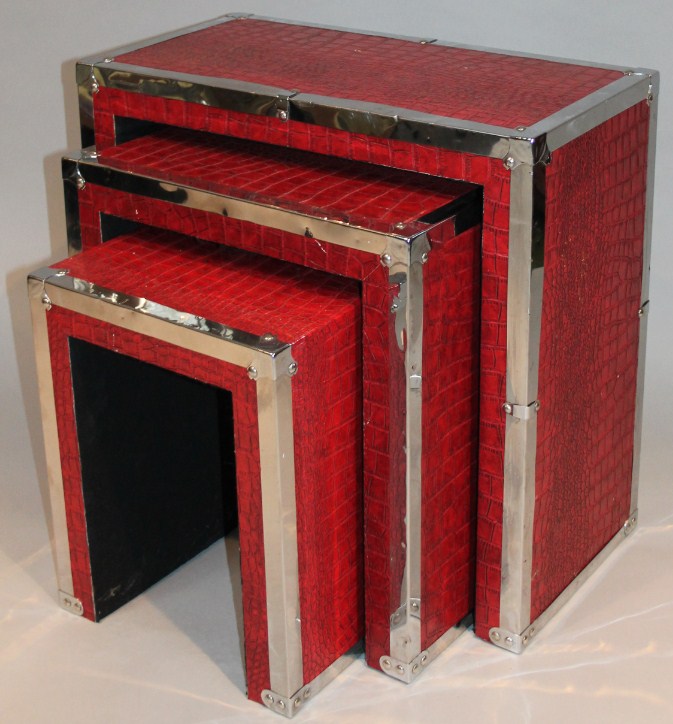 Appraisal: A nest of three modern tables in red leatherette each