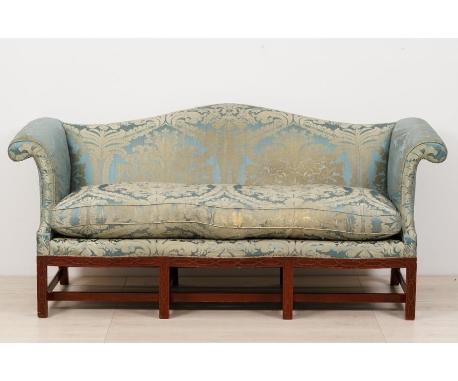 Appraisal: Chippendale style mahogany camelback sofa with damask covering blind fretwork