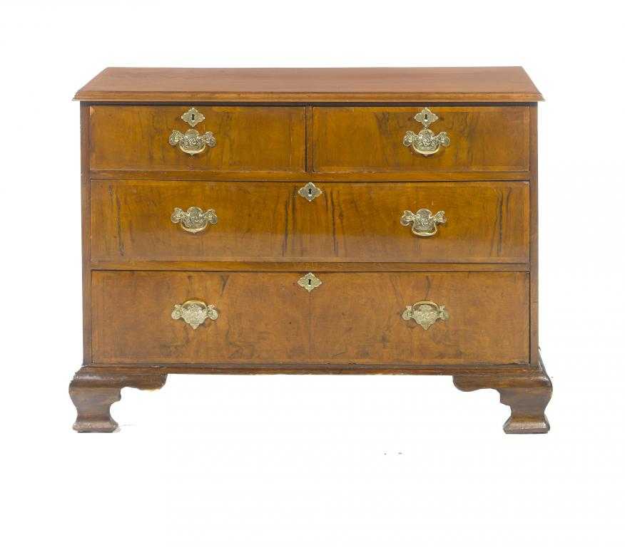 Appraisal: A WALNUT CHEST OF DRAWERS fitted two short and two