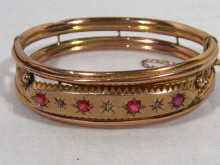 Appraisal: A carat gold bangle set with red stones and diamonds