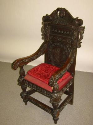 Appraisal: A VICTORIAN CARVED OAK ARMCHAIR in the th century style